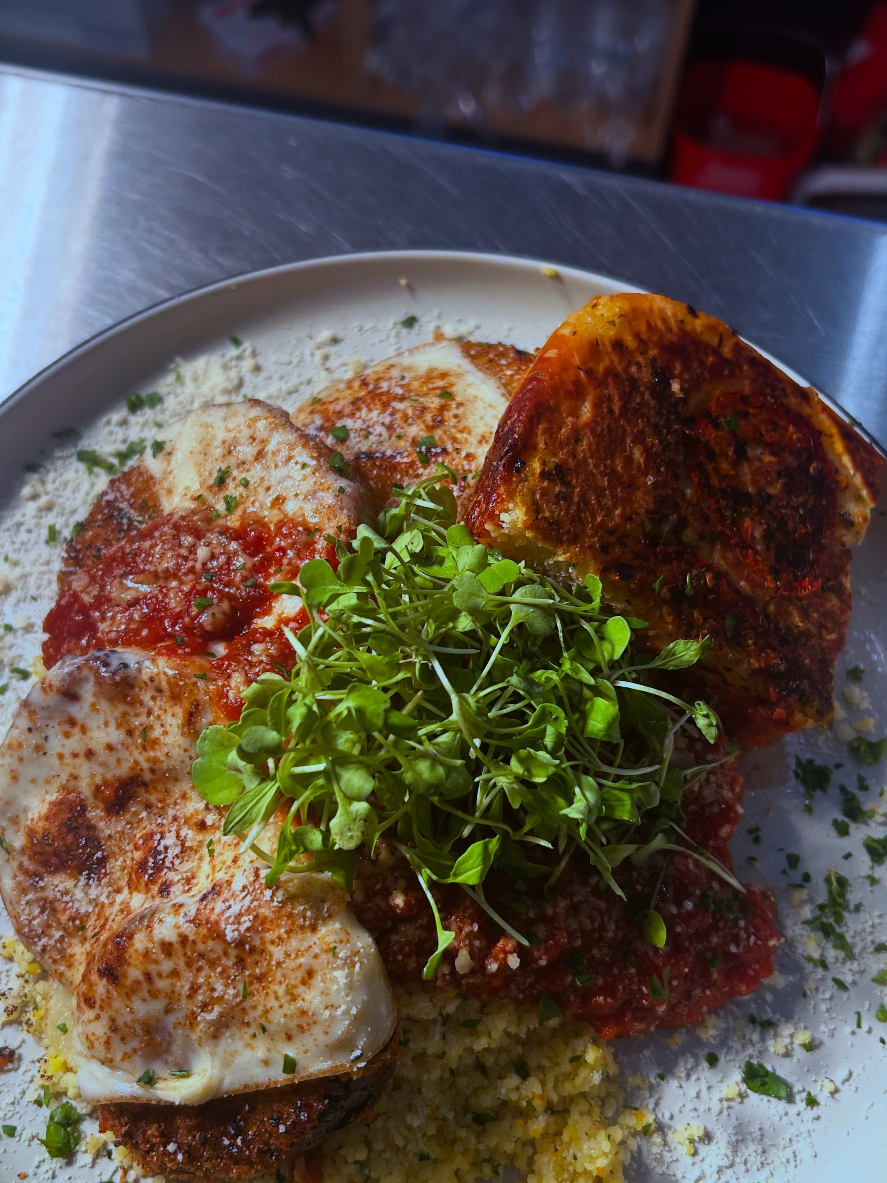 A weekly special: chicken parmesan over couscous