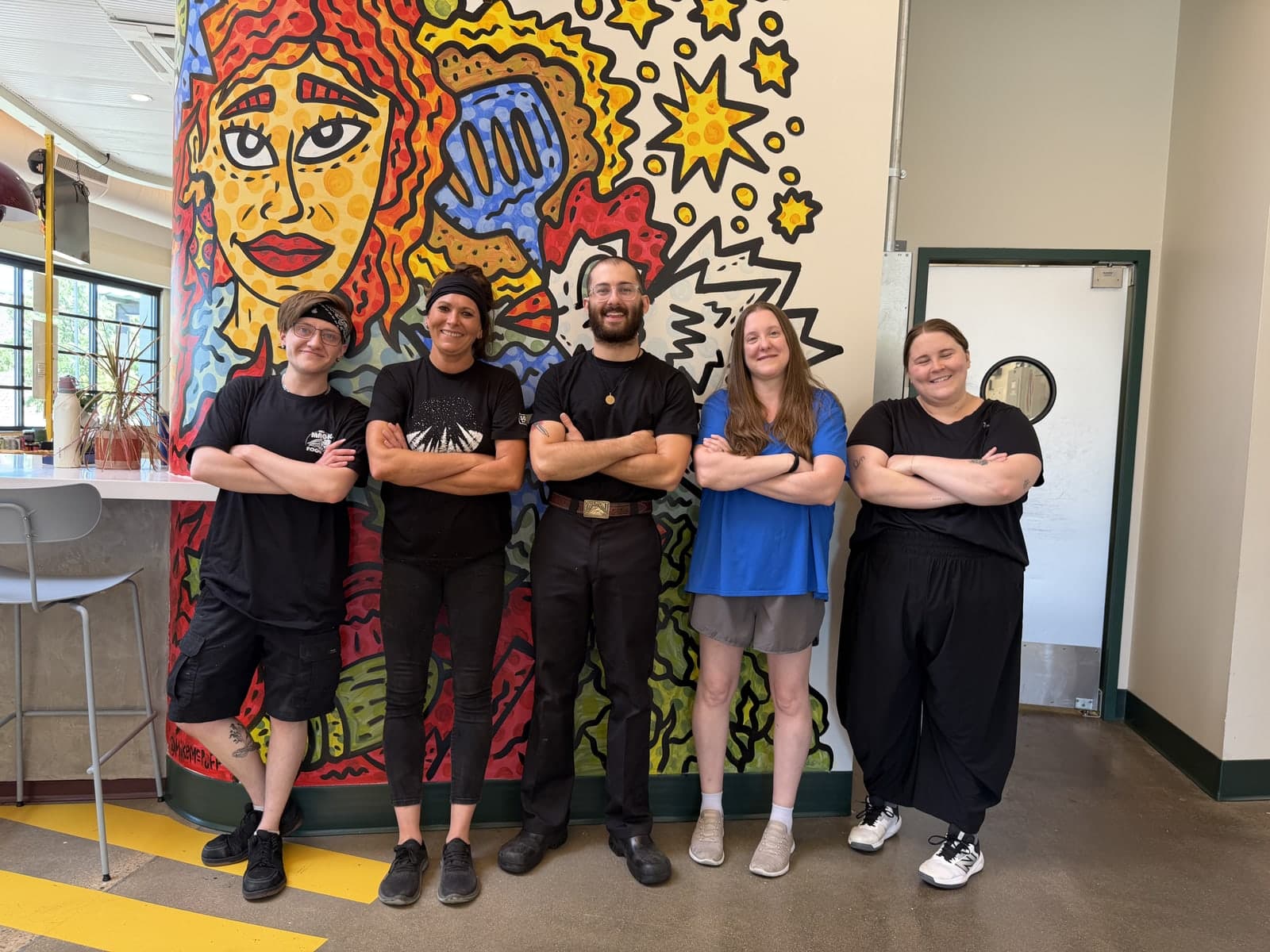 The Magic Food Bus team in front of our mural at Relish Food Hall in Louisville, CO