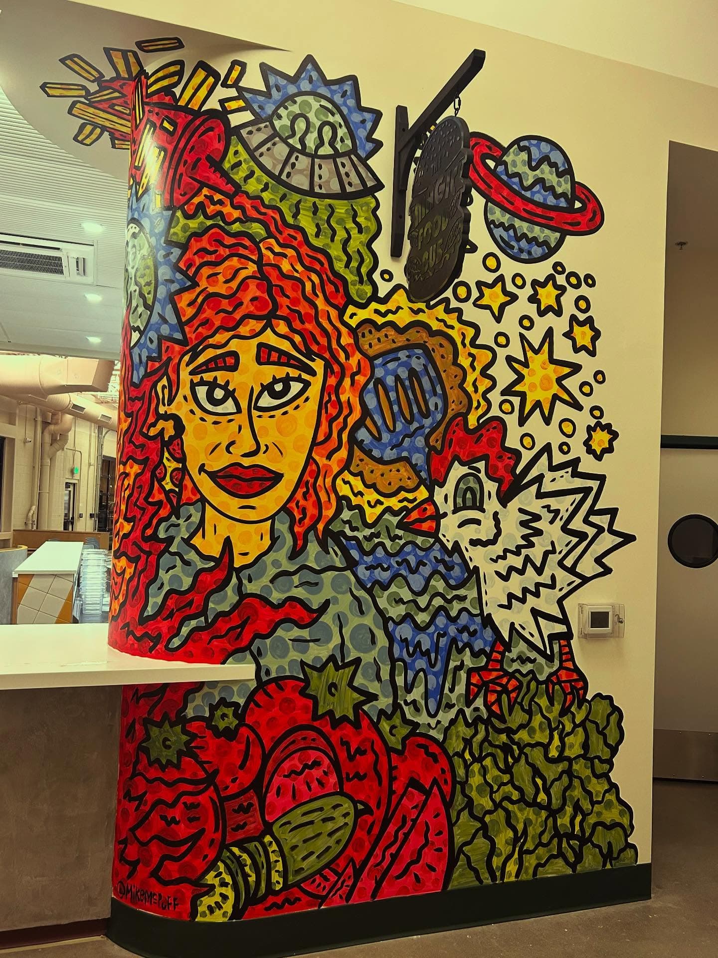 Mural at the Magic Food Bus stall inside Relish Food Hall