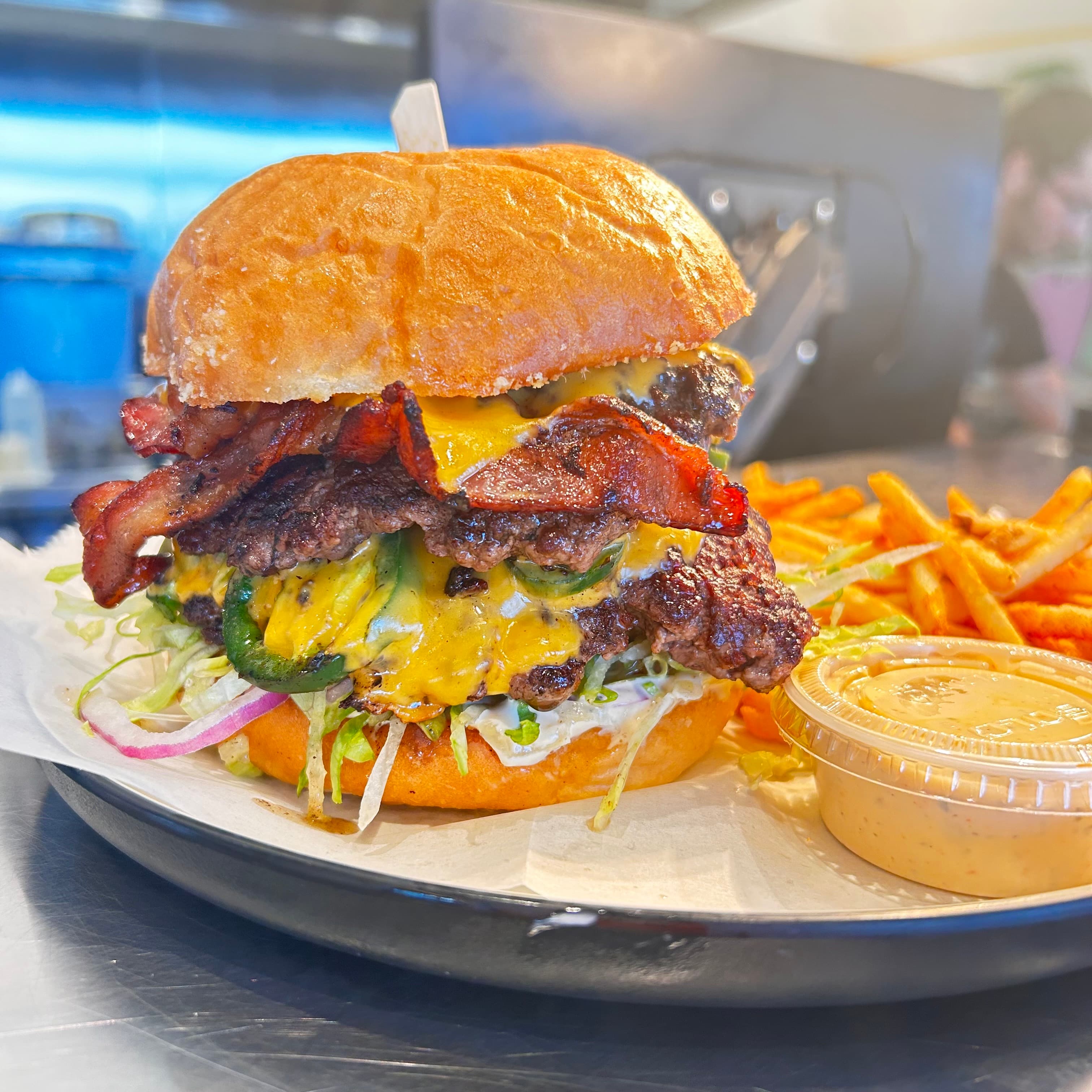 The Magic Smash, our double-stacked Colorado beef smashburger with bacon and jalapeños