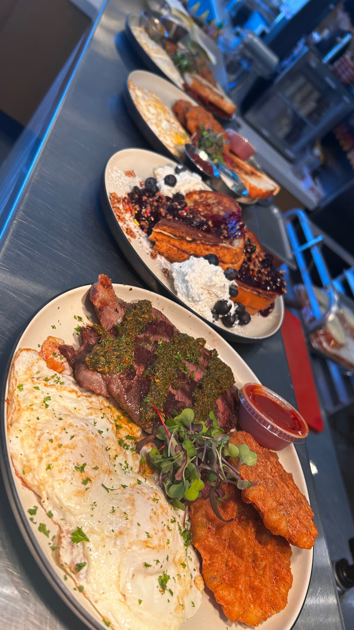 A weekly special: steak with chimichurri and over-easy eggs
